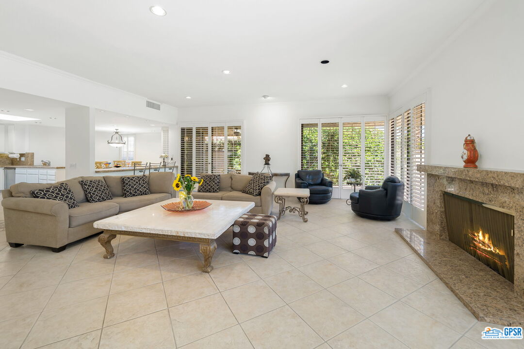 75 Colgate Drive Rancho Mirage, CA 92270 - Photo 14 of 52 a living room with furniture large window and a fireplace