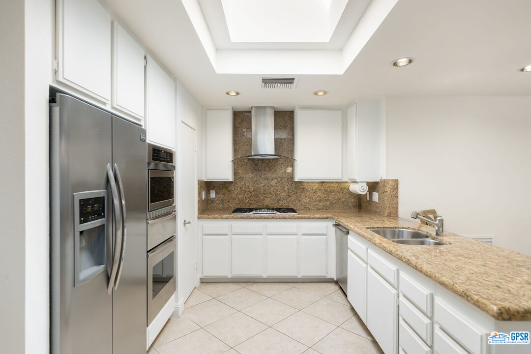 75 Colgate Drive Rancho Mirage, CA 92270 - Photo 23 of 52 a kitchen with a sink refrigerator and cabinets
