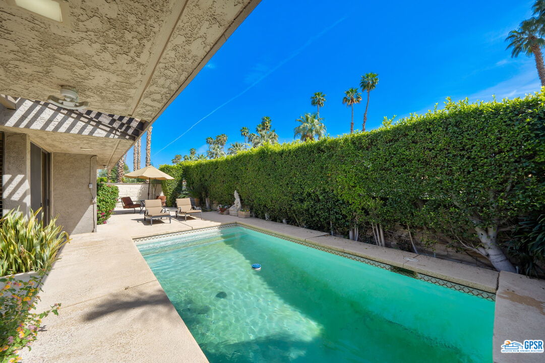 75 Colgate Drive Rancho Mirage, CA 92270 - Photo 30 of 52 a view of a patio with table and chairs and potted plants