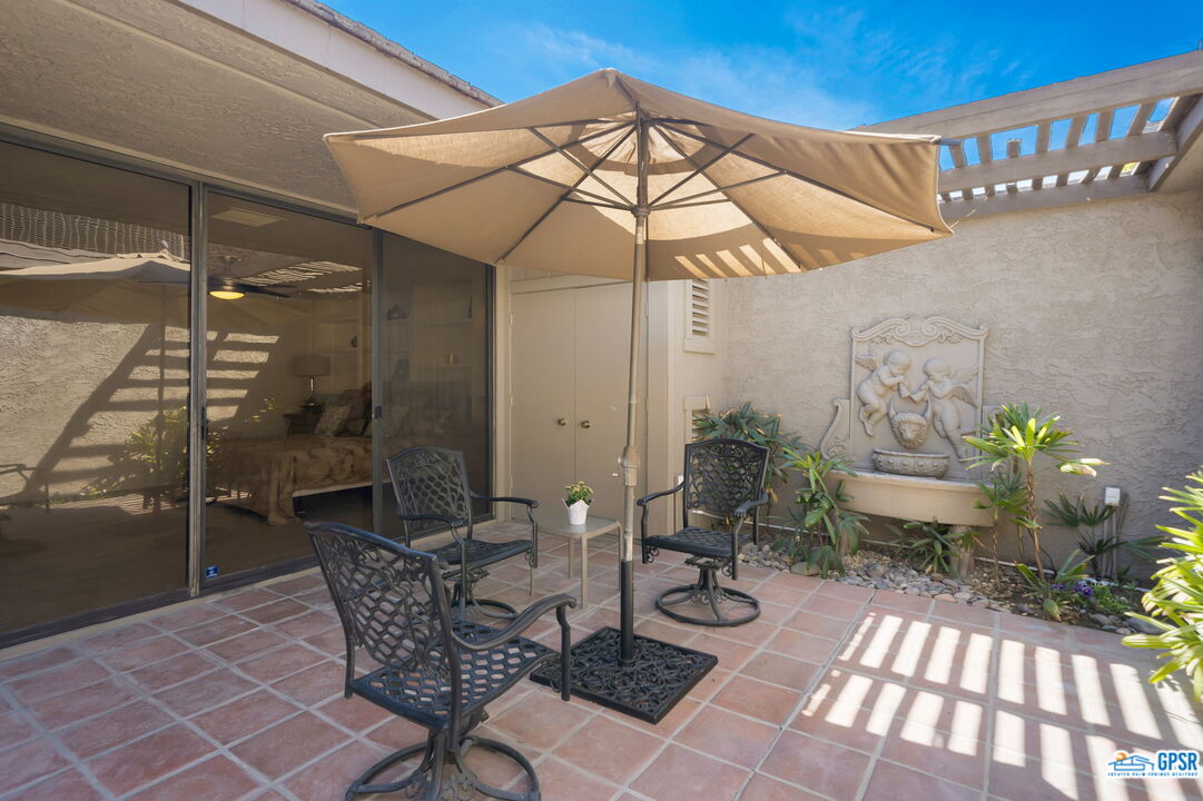 75 Colgate Drive Rancho Mirage, CA 92270 - Photo 9 of 52 a view of a patio with table and chairs potted plants