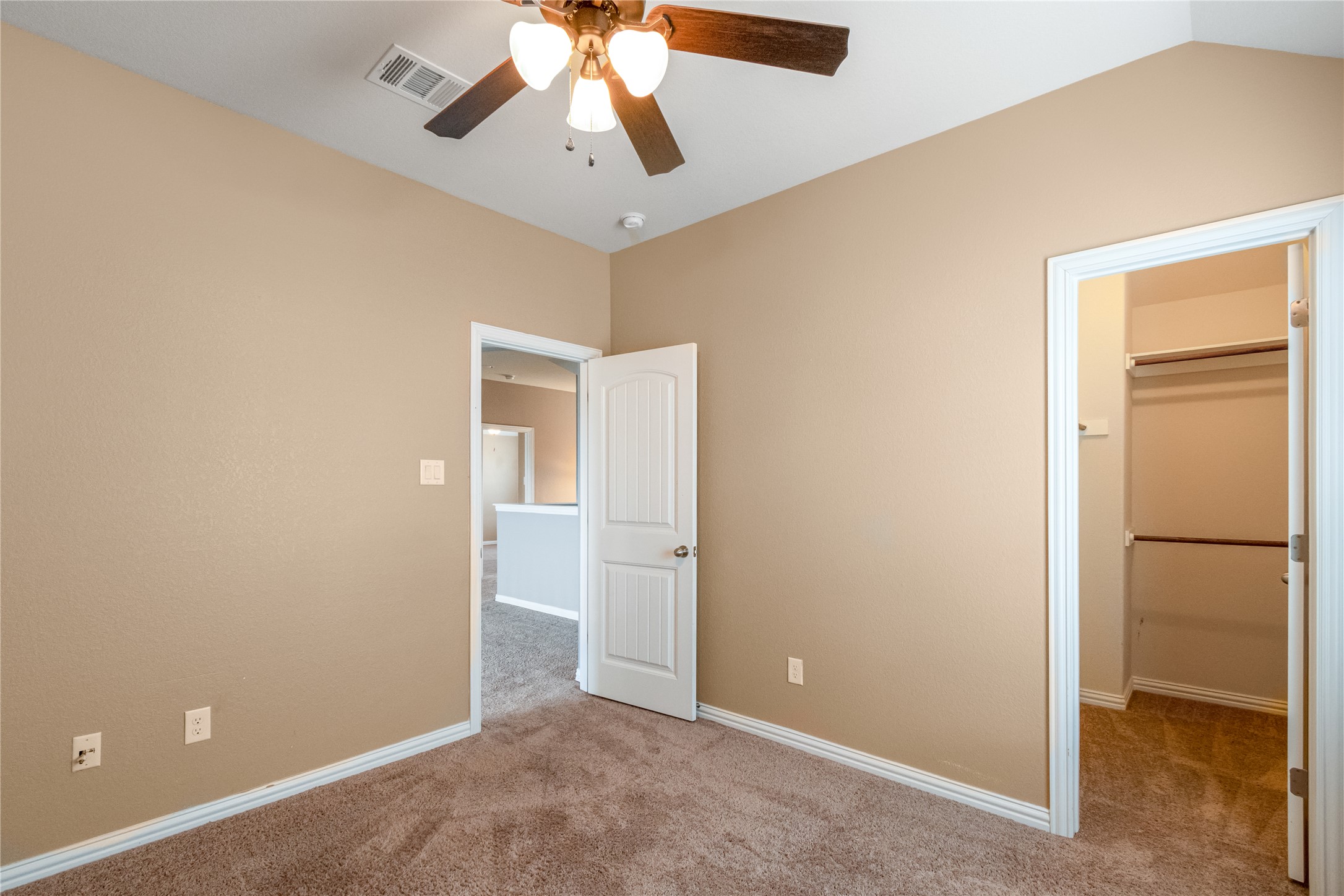 3413 Grail Hollows Road Pflugerville, TX 78660 - Photo 24 of 36 an empty room with closet and a chandelier fan