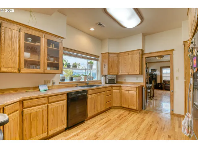 a kitchen with stainless steel appliances granite countertop a sink and cabinets