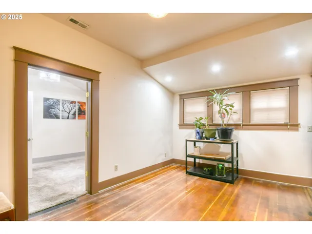 an empty room with windows and cabinet
