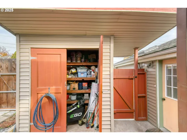 a view of a house with a yard and fence