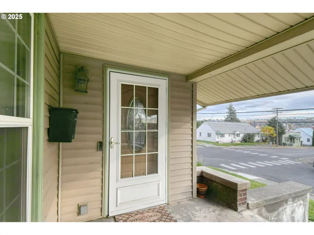 a backyard of a house with table and chairs