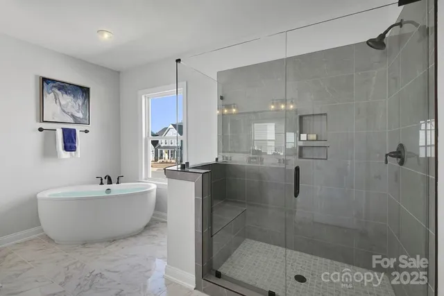 a spacious bathroom with a bathtub and shower