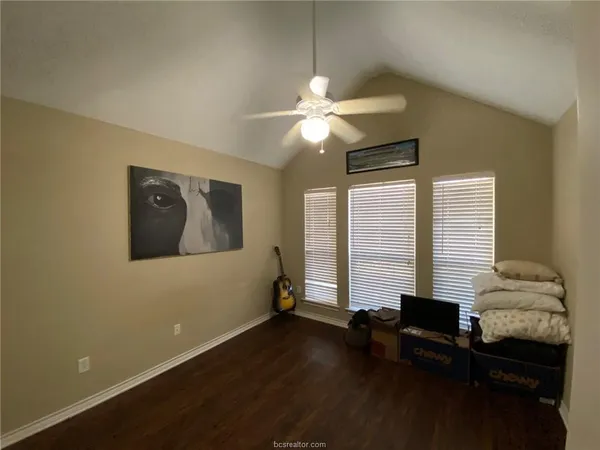 a view of a livingroom with wooden floor and a ceiling fan