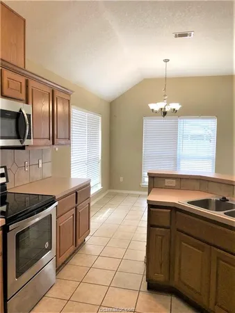 a kitchen with a sink stove and microwave