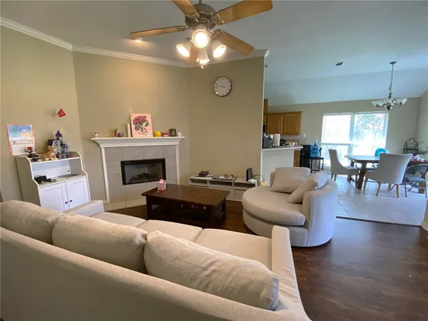 a living room with furniture dining table and a fireplace