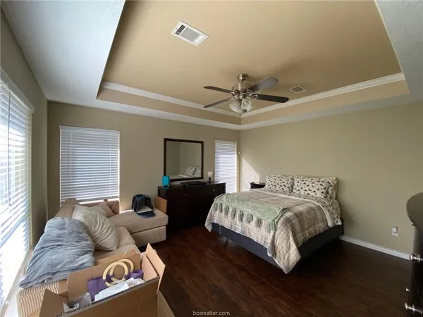 a bedroom with a bed couch and window