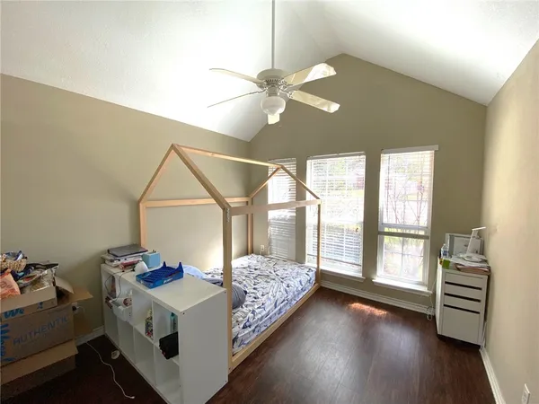 a spacious bedroom with a bed and a large window
