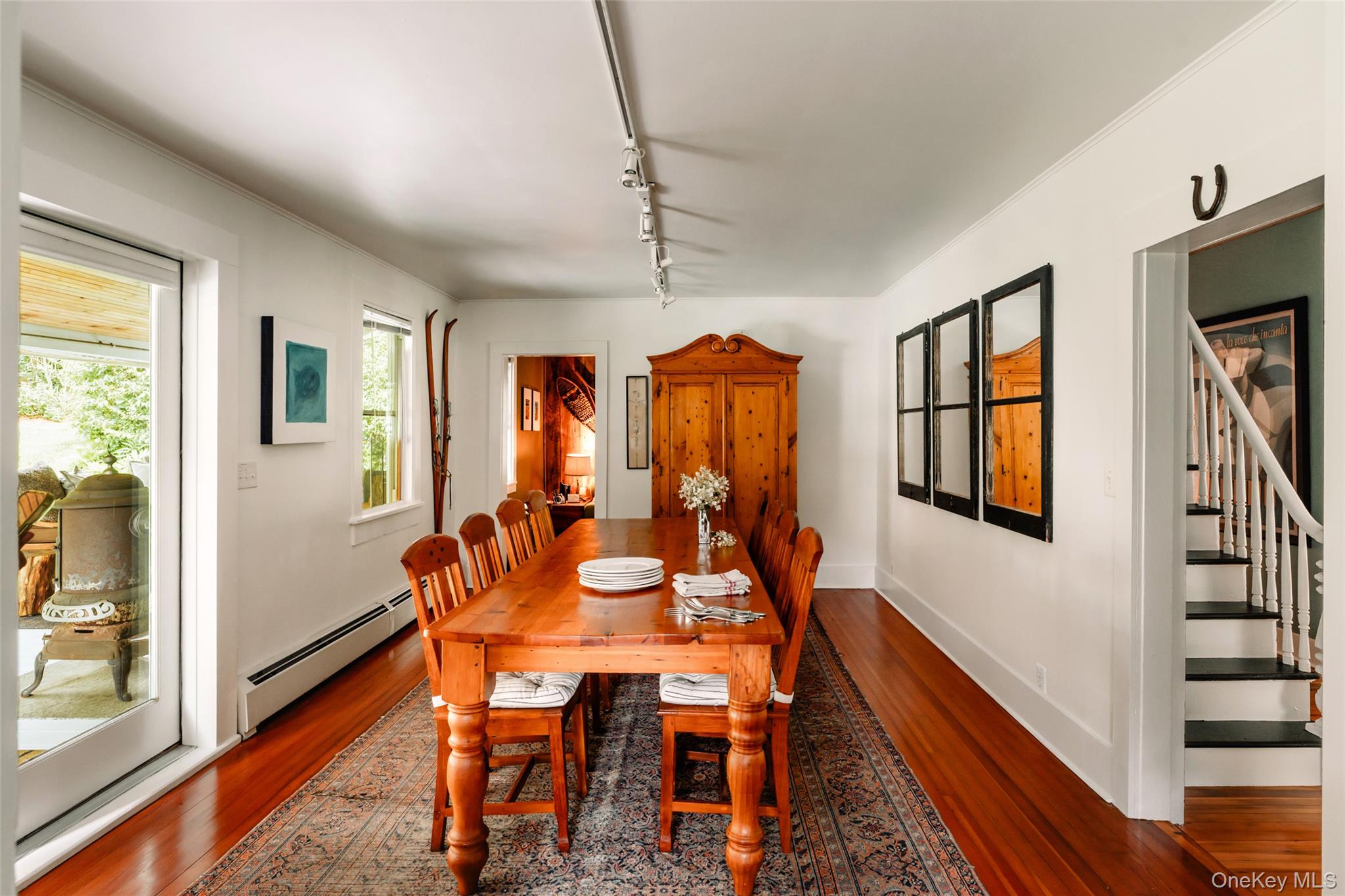 1680 Gulf Road North Branch, NY 12766 - Photo 12 of 45 Dining room with baseboard heating, dark wood finished floors, stairs, track lighting, and ornamental molding