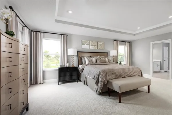 a bedroom with a bed and a potted plant