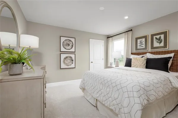 a bedroom with a bed and a large window