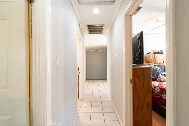 a bedroom with furniture and a flat screen tv