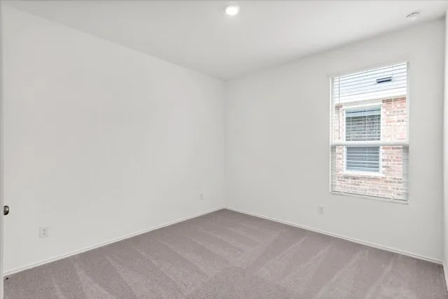 a bathroom with a granite countertop bathtub shower sink mirror vanity and toilet