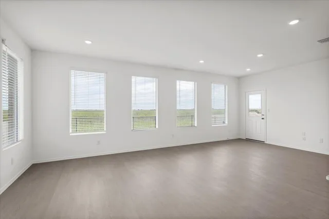 a view of kitchen with kitchen island white cabinets and stainless steel appliances