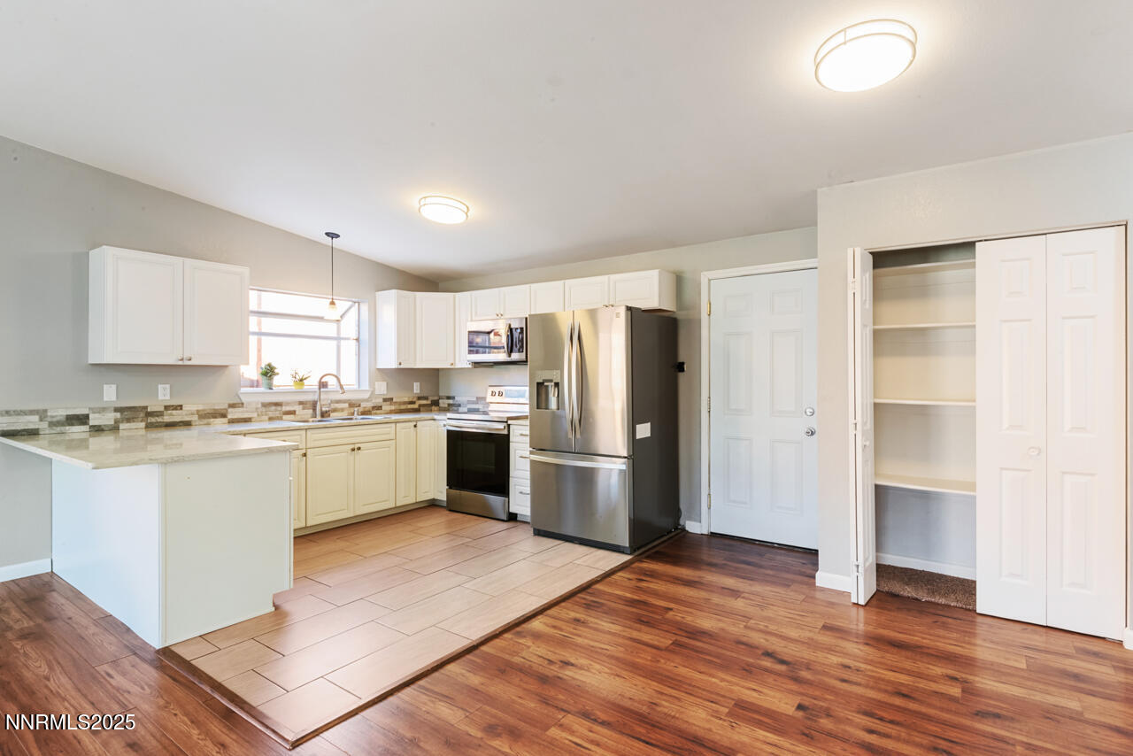 3560 Haystack Drive Carson City, NV 89705 - Photo 14 of 23 a kitchen with a refrigerator sink and cabinets