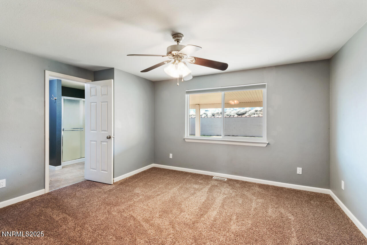 3560 Haystack Drive Carson City, NV 89705 - Photo 19 of 23 a view of an empty room with window and chandelier fan