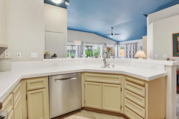 a kitchen with stainless steel appliances a refrigerator sink and cabinets