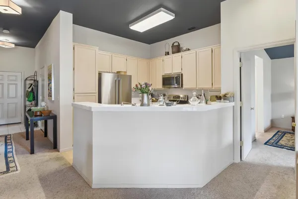 a kitchen with stainless steel appliances a refrigerator stove and microwave