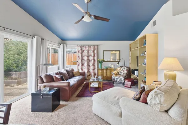 a view of a dining room with furniture and a window