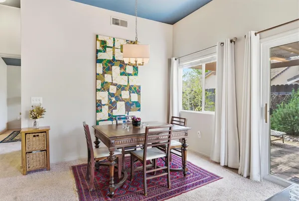 a living room with furniture a rug and a wall painting