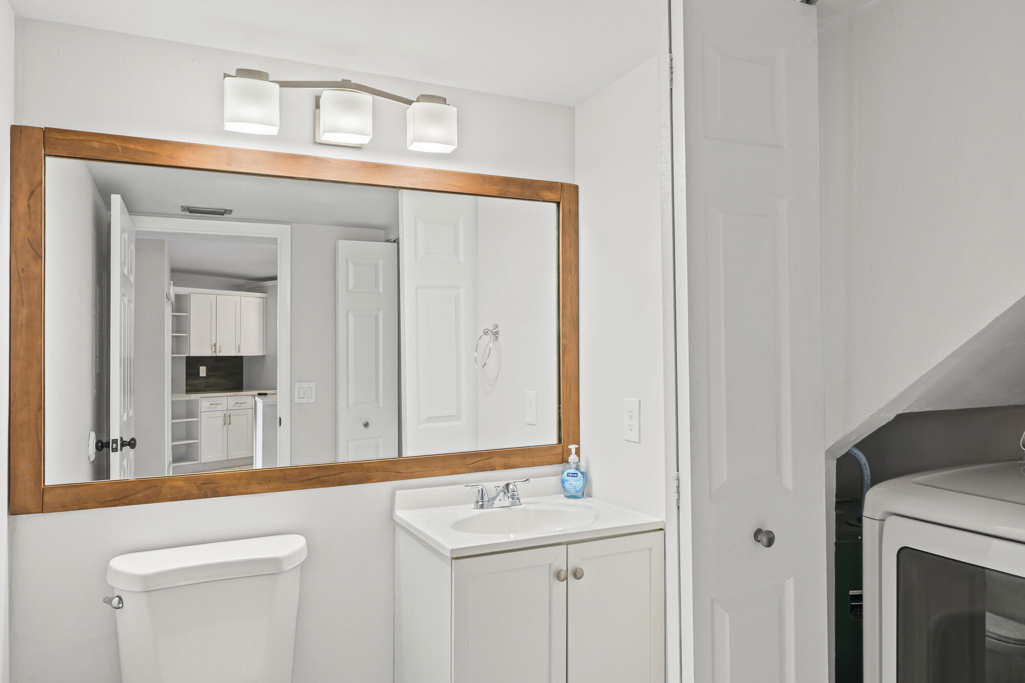 8194 Thames Boulevard, Unit B Boca Raton, FL 33433 - Photo 15 of 49 a bathroom with a sink a mirror and next to a window