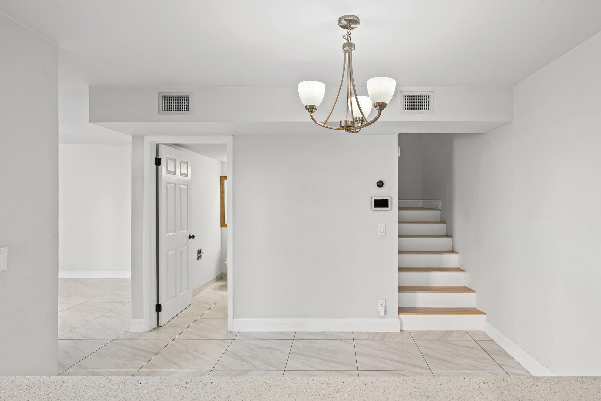 8194 Thames Boulevard, Unit B Boca Raton, FL 33433 - Photo 16 of 49 a view of a hallway with wooden cabinets and staircase