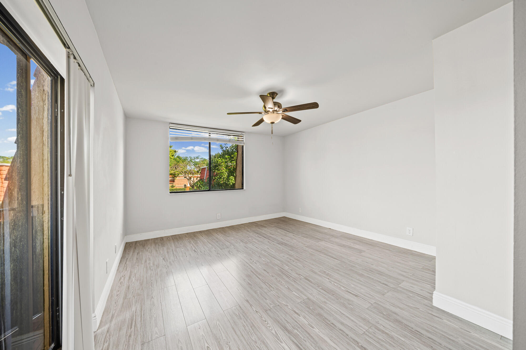 8194 Thames Boulevard, Unit B Boca Raton, FL 33433 - Photo 21 of 49 wooden floor in an empty room with a window