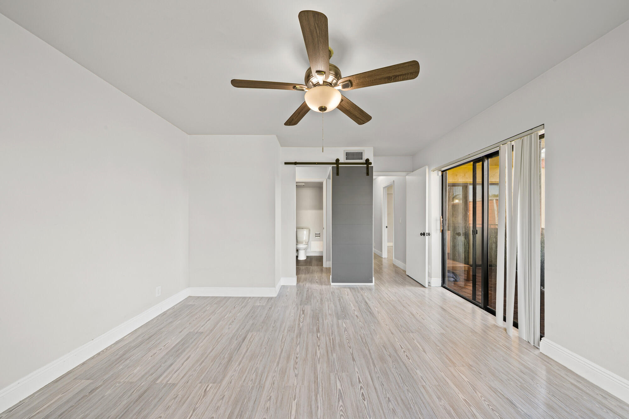 8194 Thames Boulevard, Unit B Boca Raton, FL 33433 - Photo 22 of 49 a view of empty room with wooden floor and fan