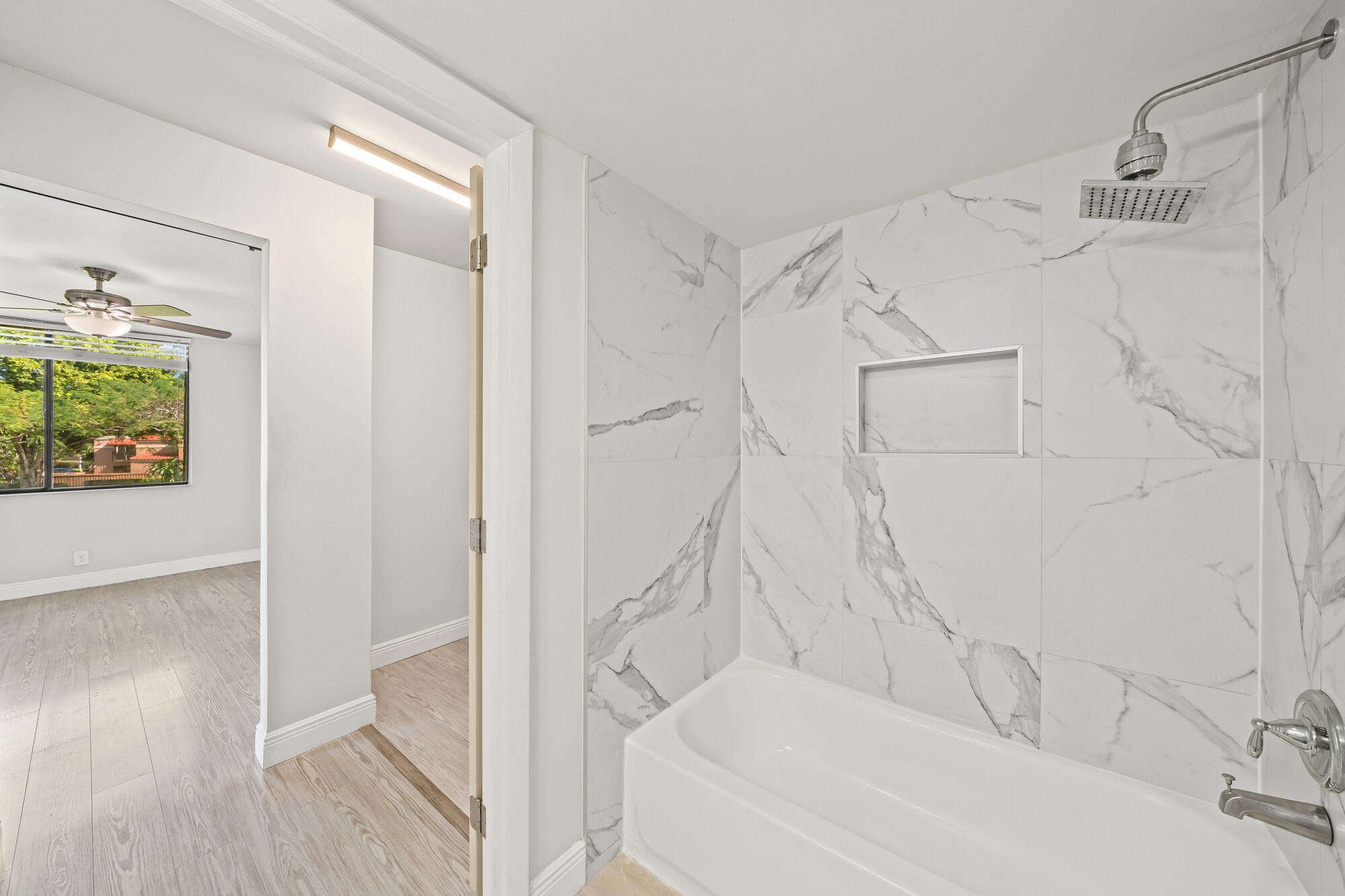 8194 Thames Boulevard, Unit B Boca Raton, FL 33433 - Photo 26 of 49 a bathroom with a bathtub and a shower