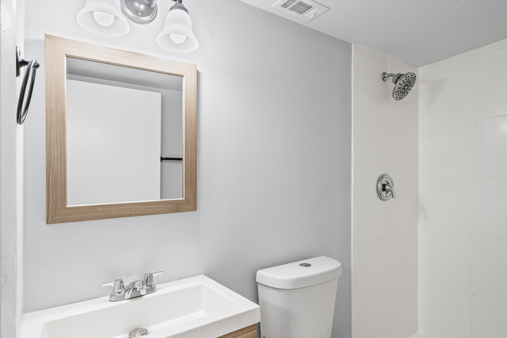 8194 Thames Boulevard, Unit B Boca Raton, FL 33433 - Photo 35 of 49 a bathroom with a toilet a sink and mirror