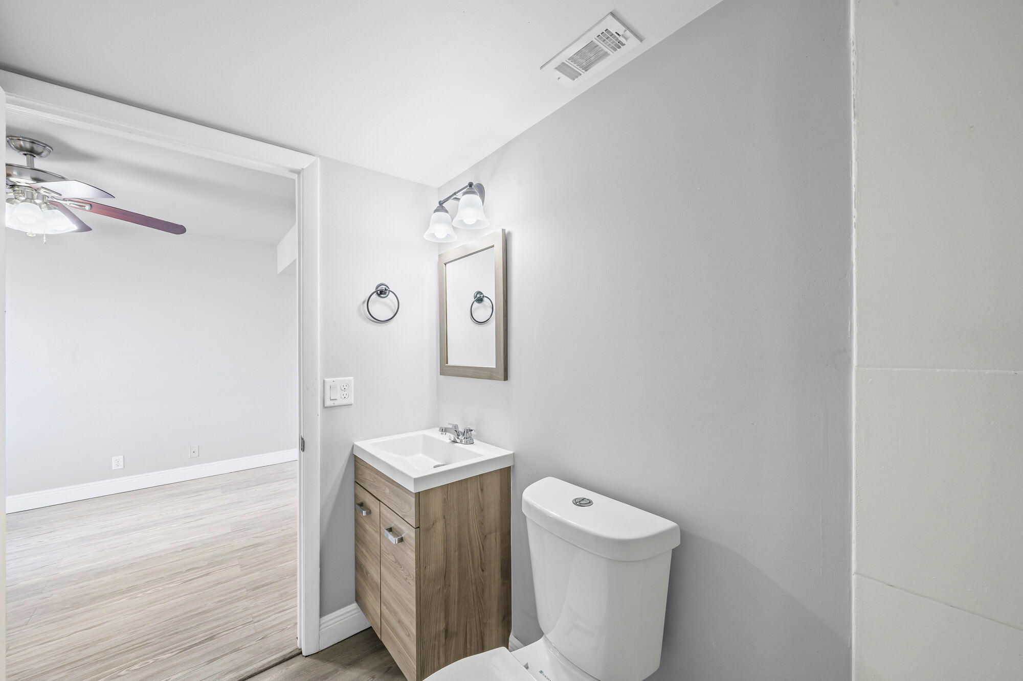 8194 Thames Boulevard, Unit B Boca Raton, FL 33433 - Photo 37 of 49 a bathroom with a toilet sink and mirror