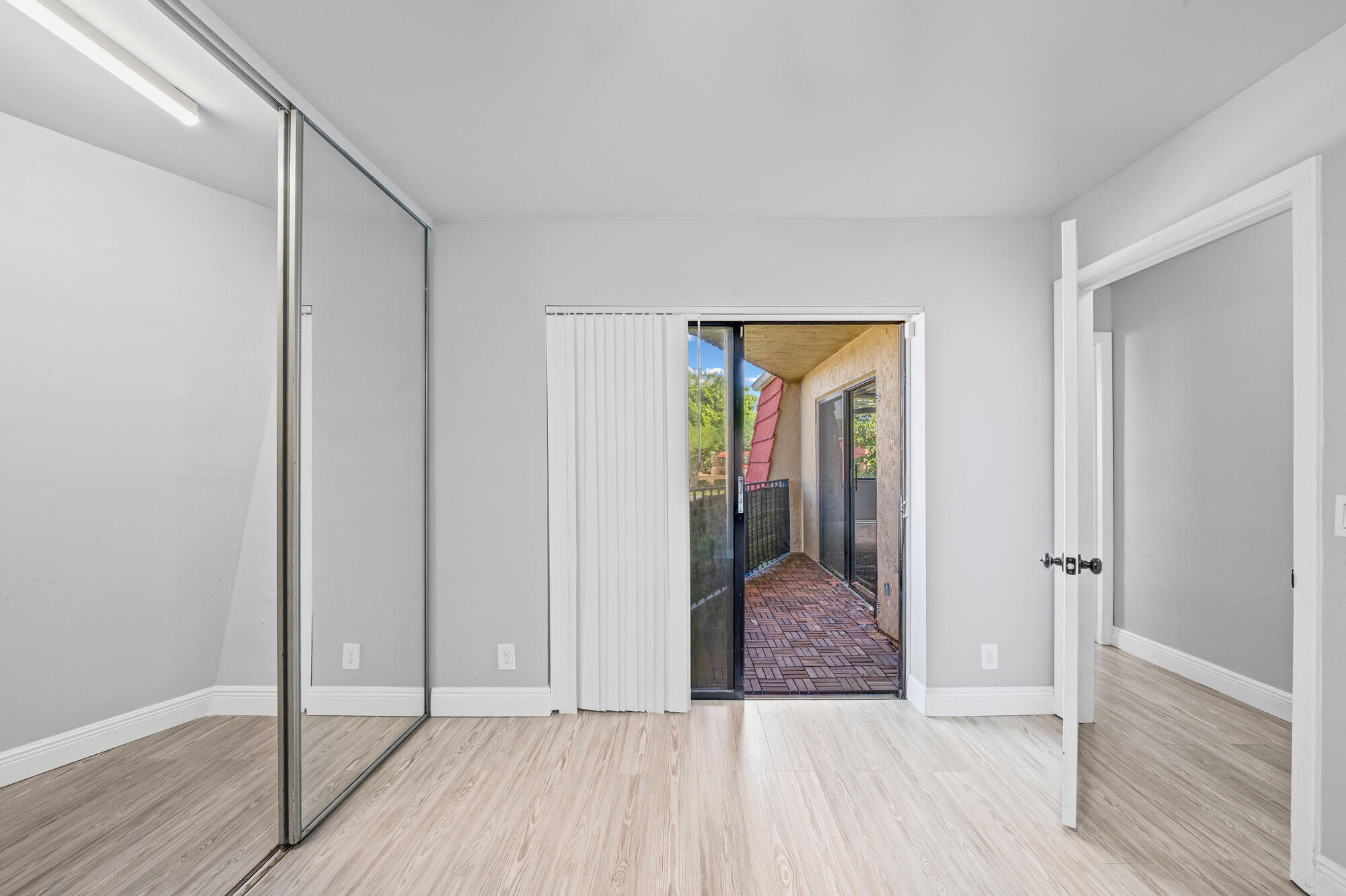 8194 Thames Boulevard, Unit B Boca Raton, FL 33433 - Photo 39 of 49 a view of hallway with walk in closet and wooden floor