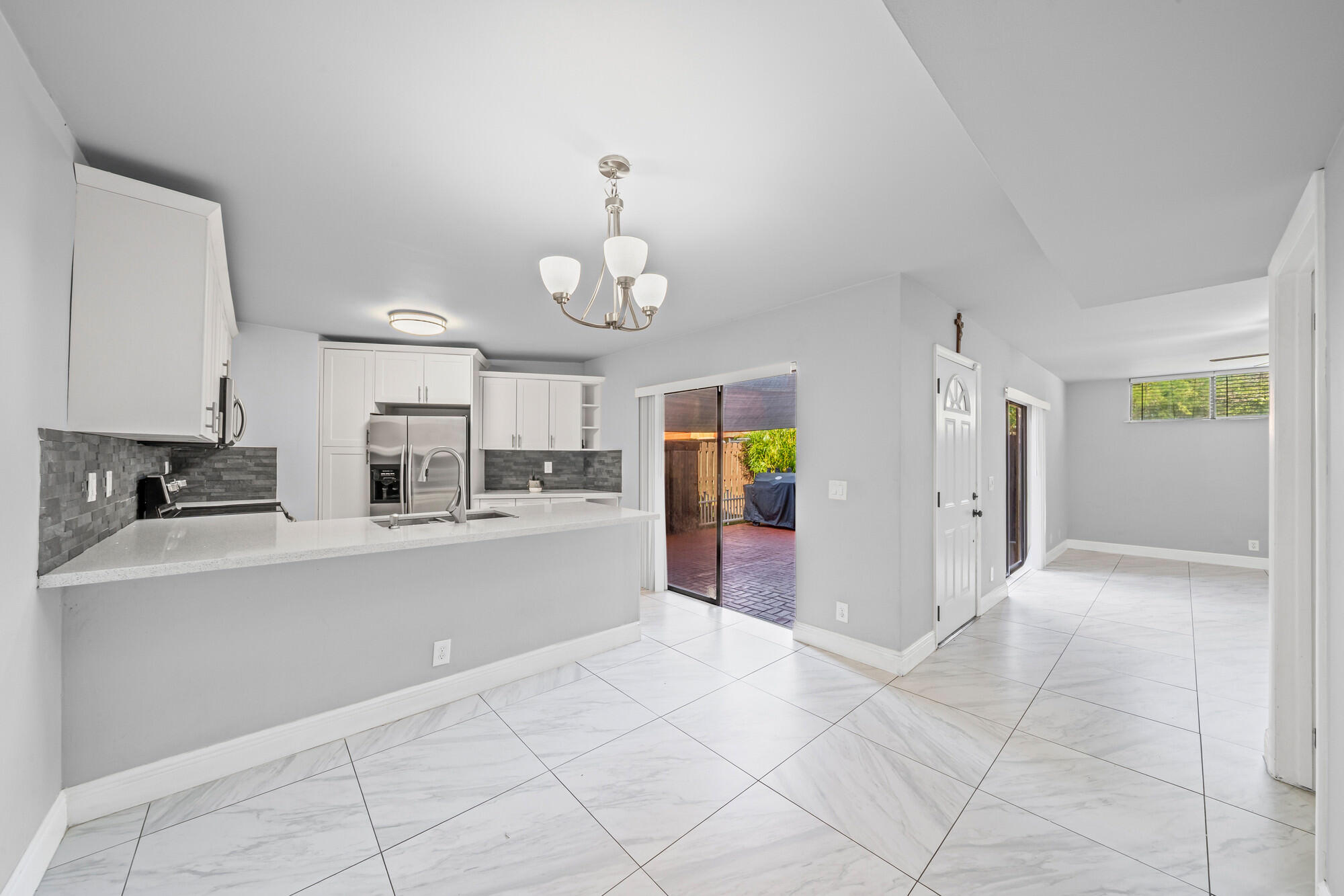 8194 Thames Boulevard, Unit B Boca Raton, FL 33433 - Photo 42 of 49 a open kitchen with cabinets and stainless steel appliances