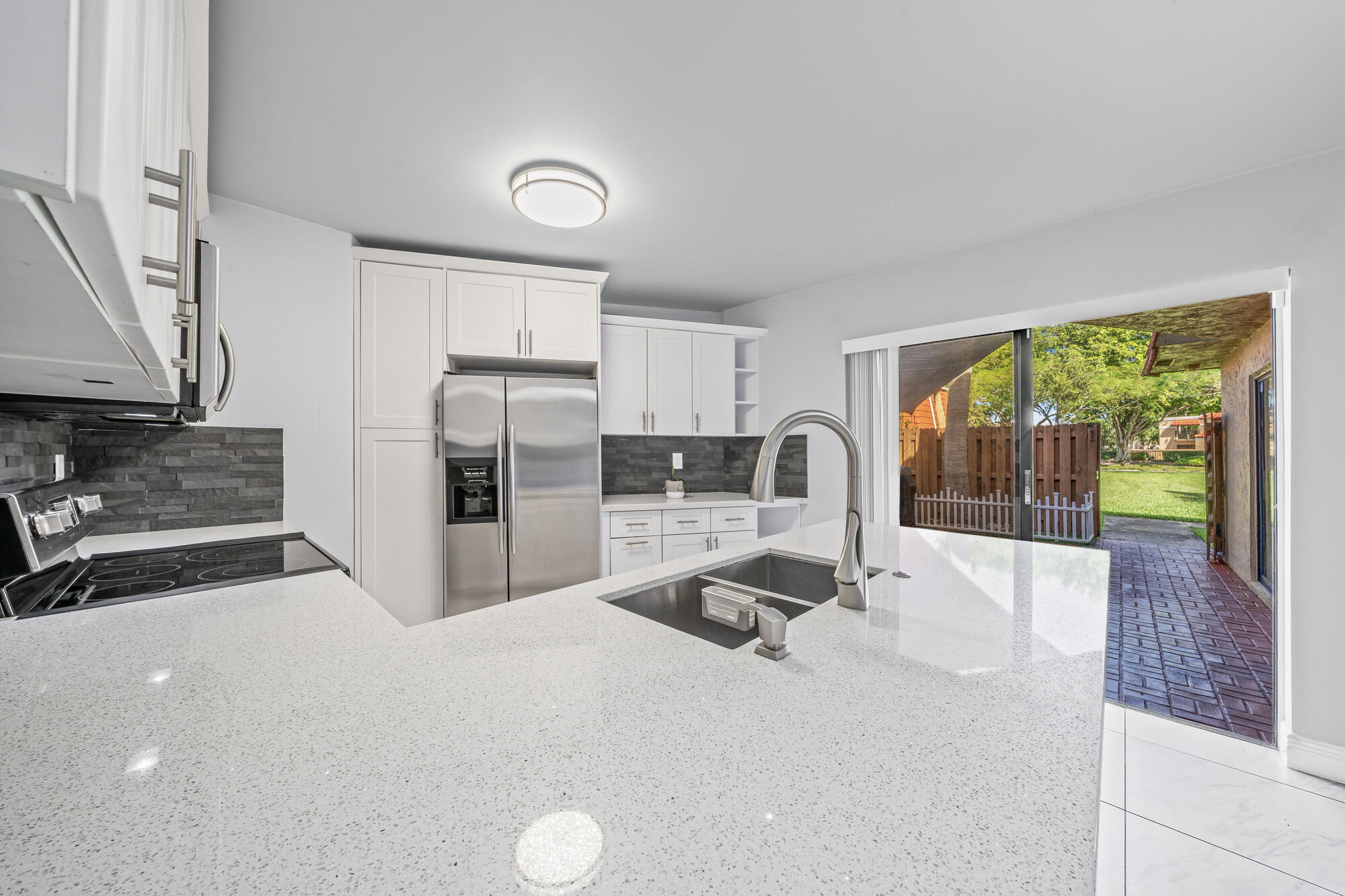 8194 Thames Boulevard, Unit B Boca Raton, FL 33433 - Photo 43 of 49 a kitchen with stainless steel appliances a stove refrigerator sink and cabinets
