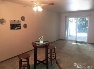 a view of a dining room with furniture and chandelier fan