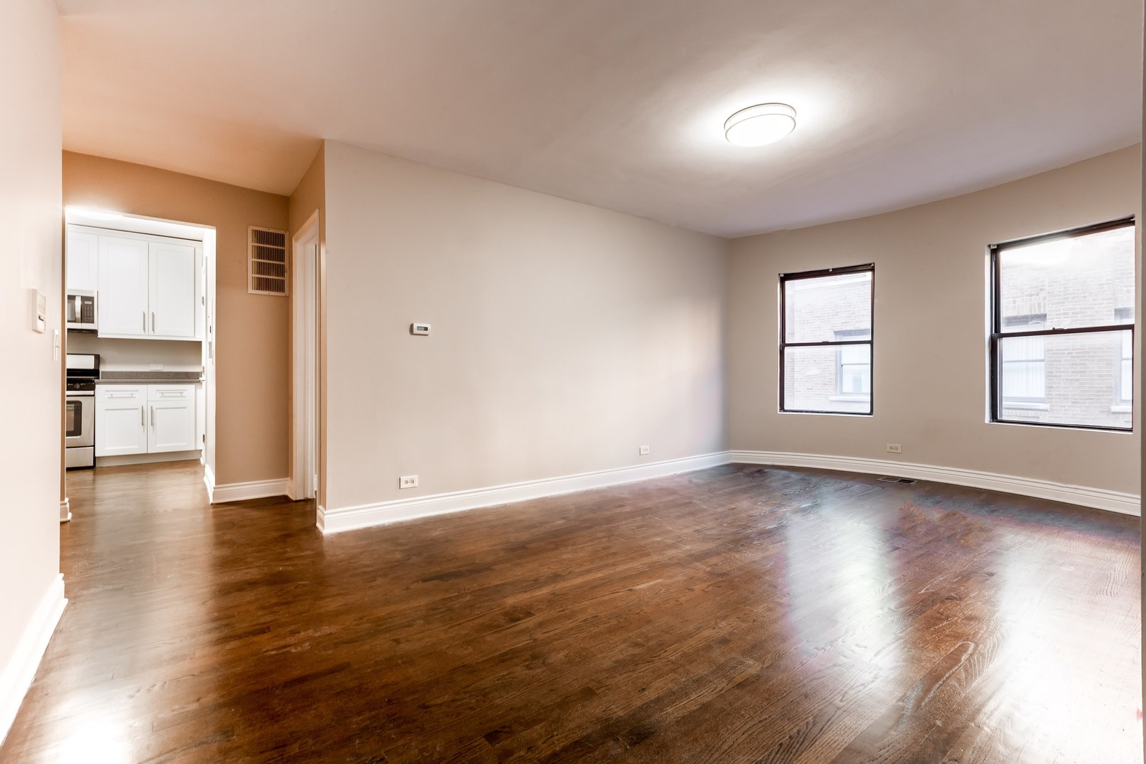 4529.5 South Drexel Boulevard, Unit 2W Chicago, IL 60653 - Photo 4 of 11 an empty room with wooden floor and windows