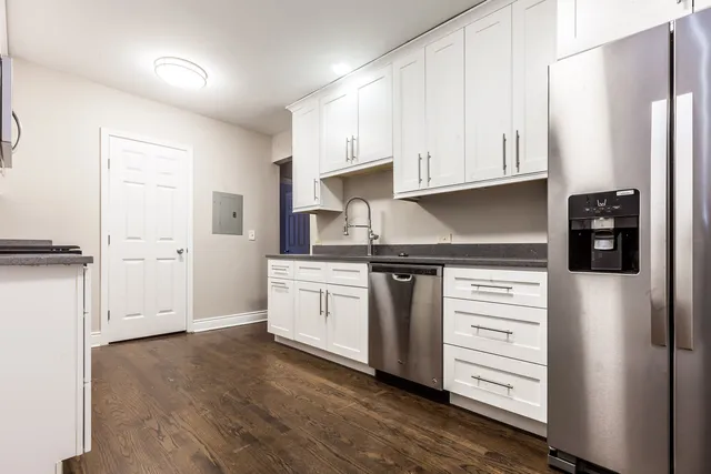 a kitchen with stainless steel appliances a refrigerator and cabinets