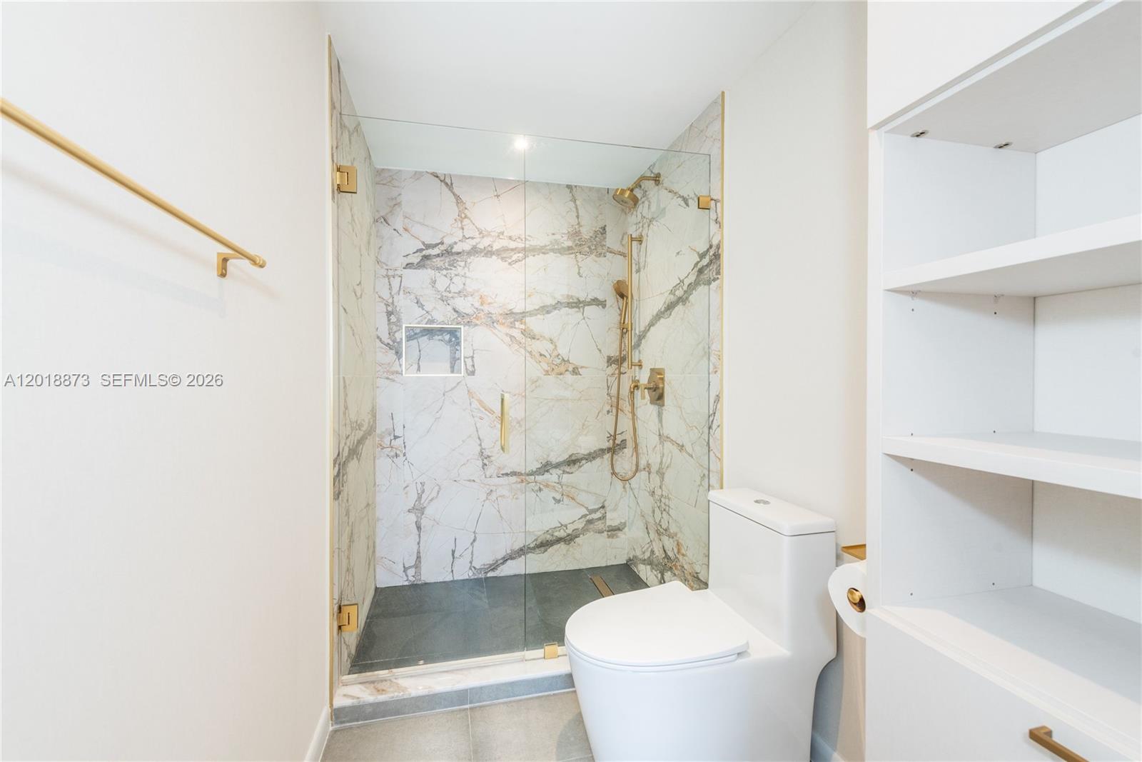848 Brickell Key Drive, Unit 2703 Miami, FL 33131 - Photo 12 of 30 a bathroom with a shower and a toilet