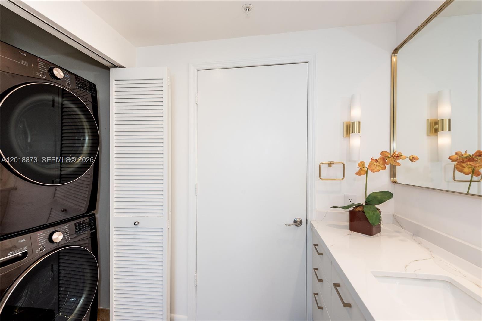 848 Brickell Key Drive, Unit 2703 Miami, FL 33131 - Photo 13 of 30 a bathroom with a sink and a mirror