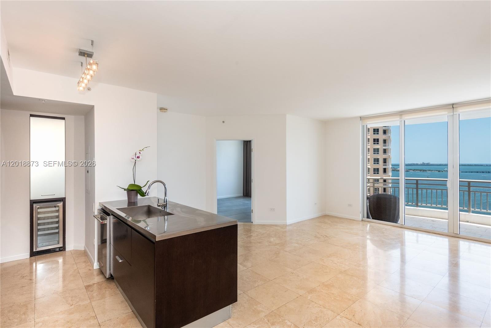 848 Brickell Key Drive, Unit 2703 Miami, FL 33131 - Photo 16 of 30 a living room with furniture and a open kitchen view