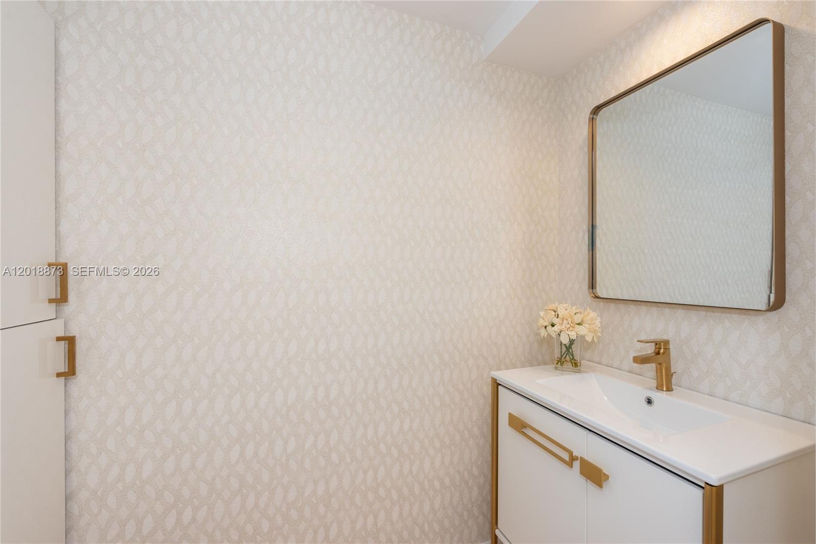 848 Brickell Key Drive, Unit 2703 Miami, FL 33131 - Photo 20 of 30 a bathroom with a sink and a mirror