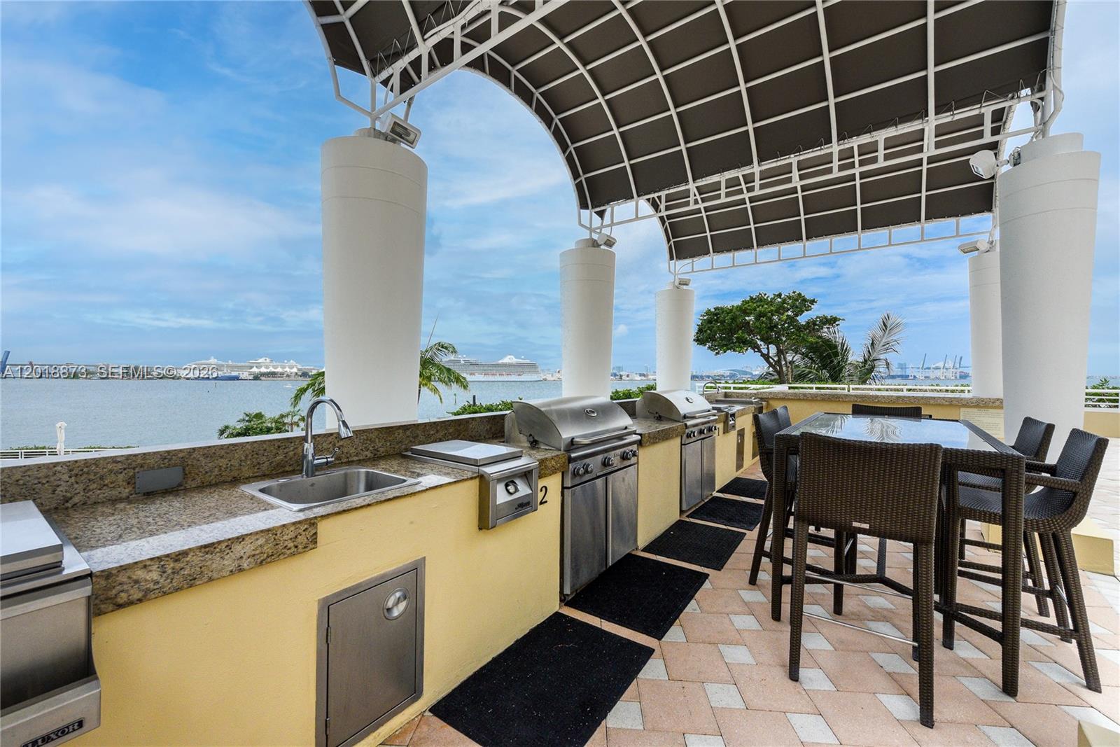 848 Brickell Key Drive, Unit 2703 Miami, FL 33131 - Photo 27 of 30 a kitchen with a sink and cabinets
