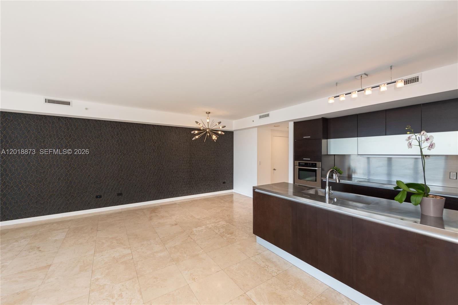 848 Brickell Key Drive, Unit 2703 Miami, FL 33131 - Photo 6 of 30 a view of kitchen with stainless steel appliances a sink and cabinets