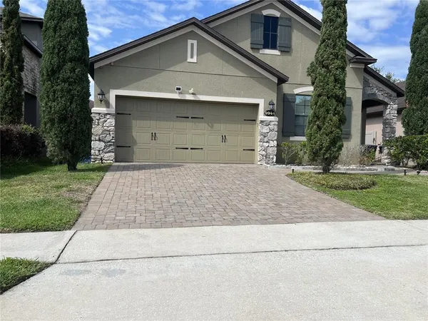 a front view of a house with a yard and garage