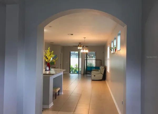a view of a hallway with furniture and a potted plant