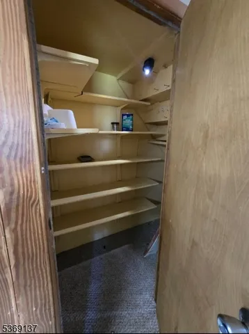 an empty room with windows and fireplace