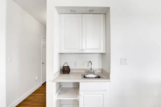 a kitchen with a sink and cabinets